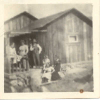 People in front of a cottage