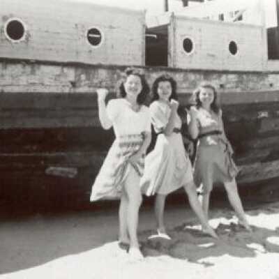 beached boat with girls