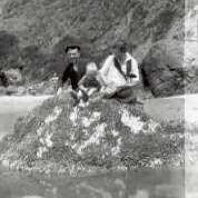 Couple and child sitting on rock