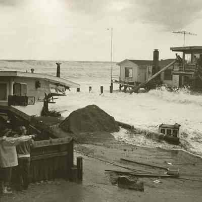 Syd Boyle in front of collapsed house