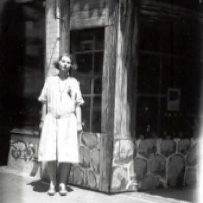 Girl Standing by Building