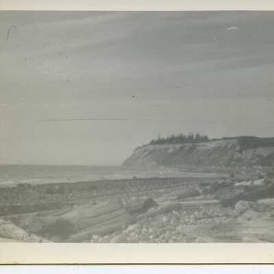 Beach with open ridgeline and partial trees on ridgeline.