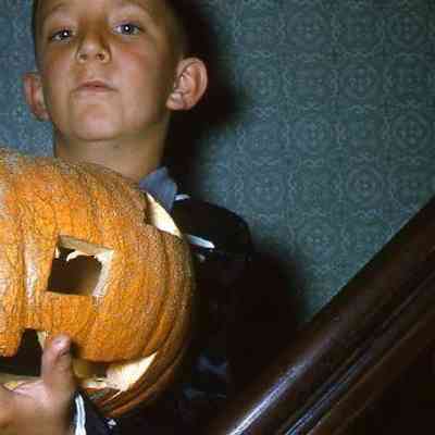 24. KJH holding carved pumpkin - Oct. 1960: Zylstra House