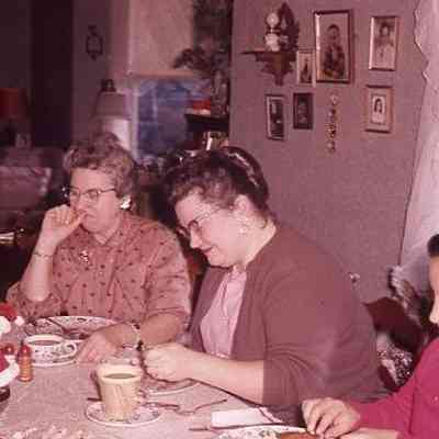 33. EYH, KJH, June Wright, Rev. Wright (Methodist Minister) at dining table, Christmas pancake breakfast: Monk House - ca. 1960