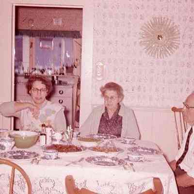 35. KJH, EYH, MCC, and JRC at dinner table. Likely Sunday afternoon meal. Usual cheery group: Zylstra House - ca. 1959