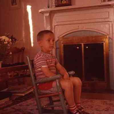 40. KJH sitting in chair by fireplace: Zylstra House - June 1957