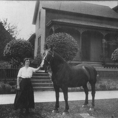 Woman standing with horse