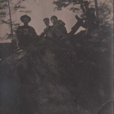 Four soldiers sitting on small cliff: Origsize: 3.5x5.5; Origformat: Print-Photographic