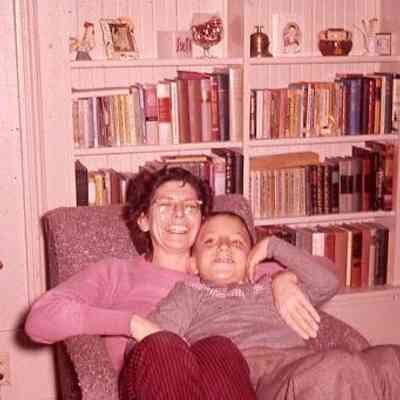 52. KJH and JJC smiling in living room chair: Zylstra House - Dec. 1959