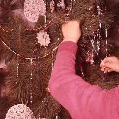 53. KJH decorating Christmas tree: Zylstra House - Dec. 1959