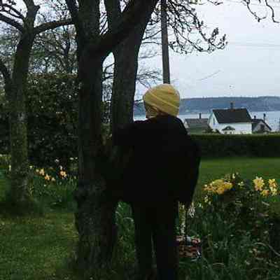 58. KJH in side yard with Easter basket, Penn Cove in background: Zylstra House - April 1957