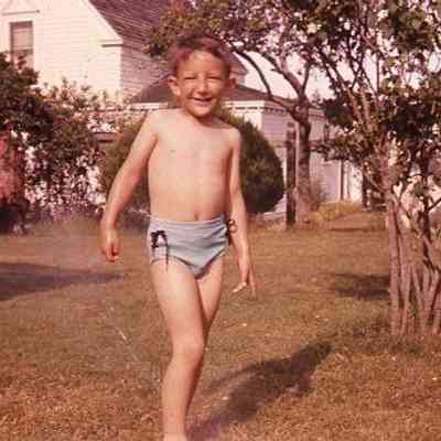 61. KJH in bathing suit with Kineth's House in background: Coupeville - summer 1958