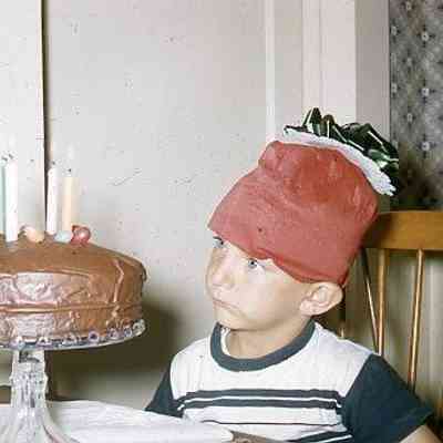 76. KJH in hat made by JJC and birthday cake: Zylstra House - Aug. 1957