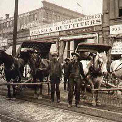 Men, Horses, and Buggies in front of Alaska Outfitters