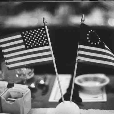13-star and 50-star flags decorate the table.