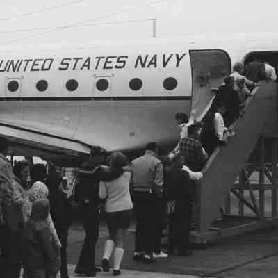 Visitors file into Navy plane.