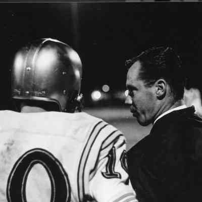 Assistant coach counsels player.