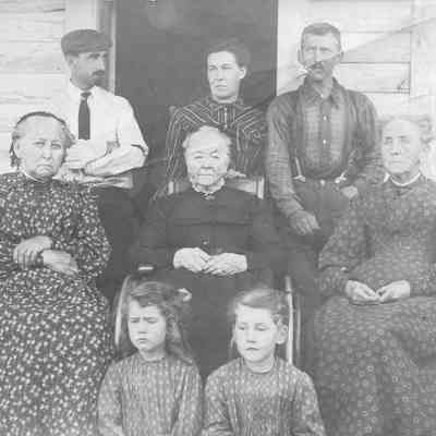 158 - Early 1905 Monroe-Morse Family Group Photo at Tony & Mamie Monroe home: Front: Lillian Amy and Ava Clara Monroe, Middle: Sarah Morse Snow, Catherine Morse Monroe (Tony's mother), Juliet Morse (3 sisters): Back: Fred Adams (cousin), Mary (Mamie) Arnold Monroe, Tony (A.W.) Monroe