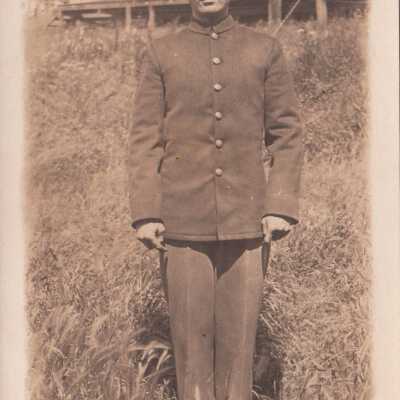 Young soldier posing in grassy field: Origsize: 3.5x5.5; Origformat: Print-Photographic