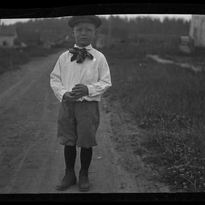 Young boy standing in road: Origsize: 5.75x3.5; Origformat: Negative