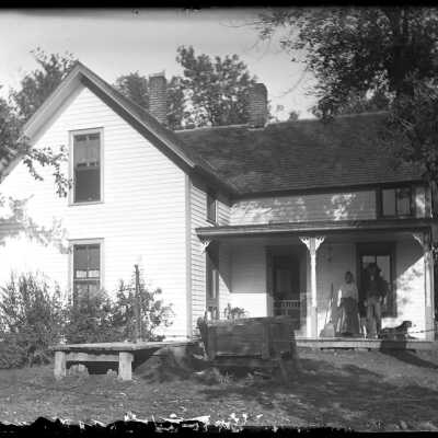 Couple on farmhouse porch: Origsize: 4x5; Origformat: Negative