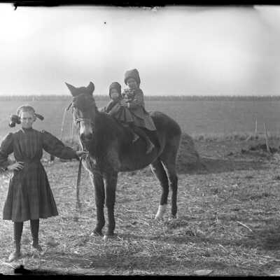 Two children on pony, girl holding reins: Origsize: 4x5; Origformat: Negative