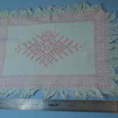 446 - doily, monk's cloth, fringed, pink cross-stitch, 17x12"
