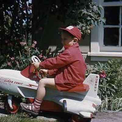 6. KJH rides toy pedal car "Murray Jet Super Sonic" by garage/shed - June 1957: Zylstra House