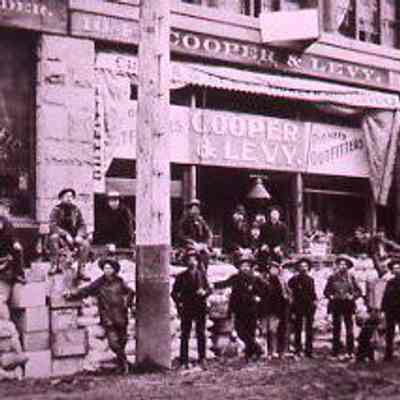 Prospectors Stand in Front of Cooper & Levy Storefront