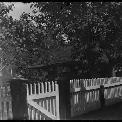 Old car outside fence: Origsize: 4x5; Origformat: Negative