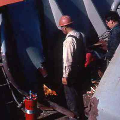 Workers Inspect Fittings