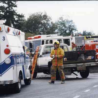 Ambulance and fire vehicles at accident scene.