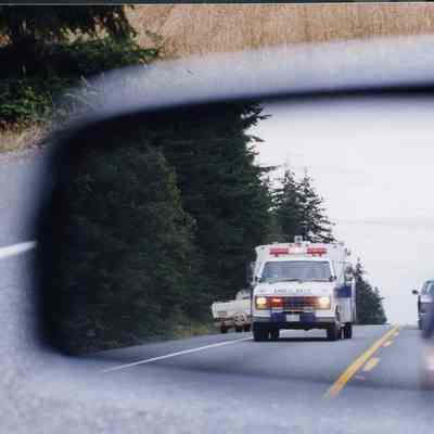Ambulance reflected in side mirror.
