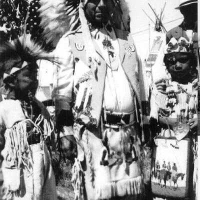 Man in head dress with small child.