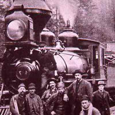 Men Posing Next to Steam Engine