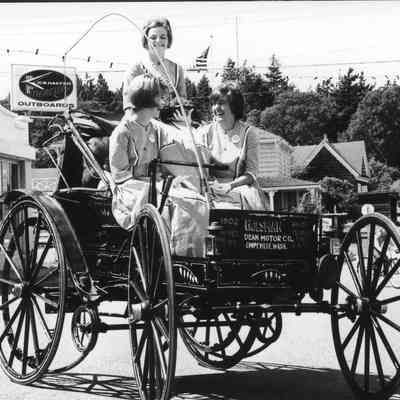 Holsman car with parade royalty.