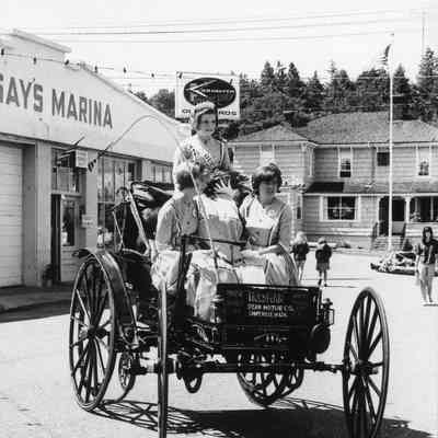 Holsman car with parade royalty.