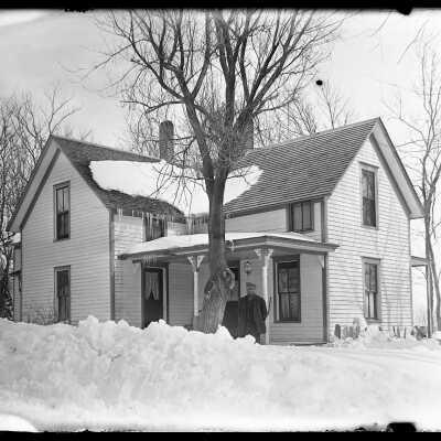Winter scene, man outside house: Origsize: 4x5; Origformat: Negative