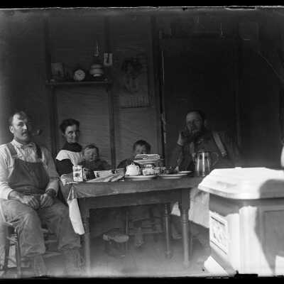 Family inside house at dining table: Origsize: 4x5; Origformat: Negative