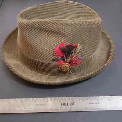 568 - man's brown corduroy Stetson w/ corduroy band w/ red/black feather and brown button