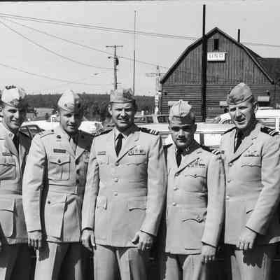 Navy officers pose at air show.