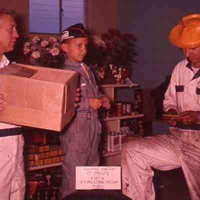 14. Brooks Service Opening Event - Sept. 1959: WKB, KJH, and unknown reading raffle ticket