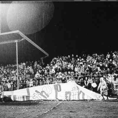 Banner in front of stands sags in the rain.