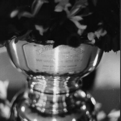 Navy League trophy filled with flowers.