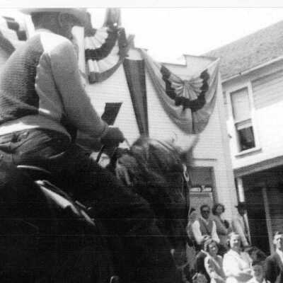 Jerry Greenaugh or Red Thompson on horeback in parade at coupeville water festival.