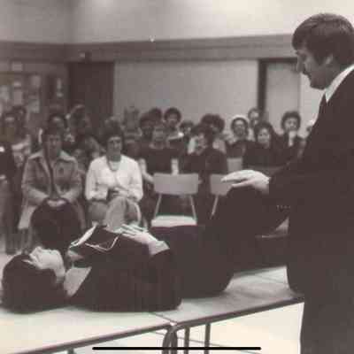 P2000-01-20-119: Thursday at 10 Meeting - Linda Coutts prone on the table - photo taken January 18,1978