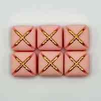 Set of six matching square buttons, pink with golden "X" motif