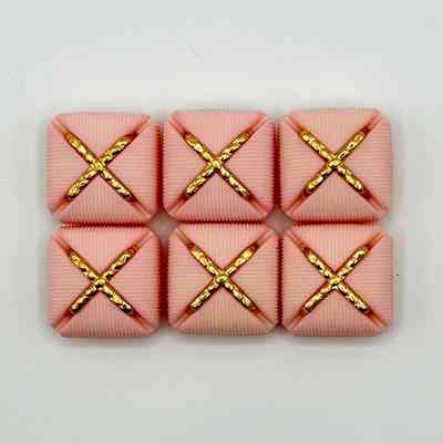 Set of six matching square buttons, pink with golden "X" motif