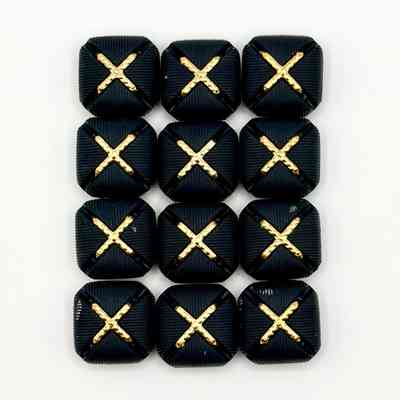 Set of twelve matching square buttons, black with golden "X" motif