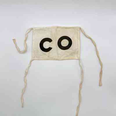Cloth armband (brassard) lettered "CO" — Comité/Comisión Organizadora